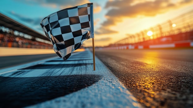 Checkered Flag Waving at Sunset During a Racing Event Near the Track With Dramatic Sky. photo