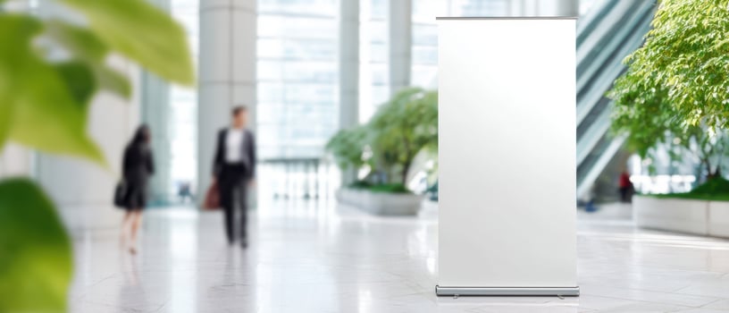 The blank banner stand in a modern corporate environment with greenery. photo