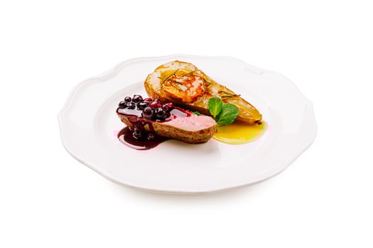 Exquisite roasted duck breast served with fruit and berry sauce photo