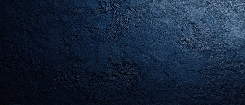 The textured dark blue wall with subtle lighting and rich details photo