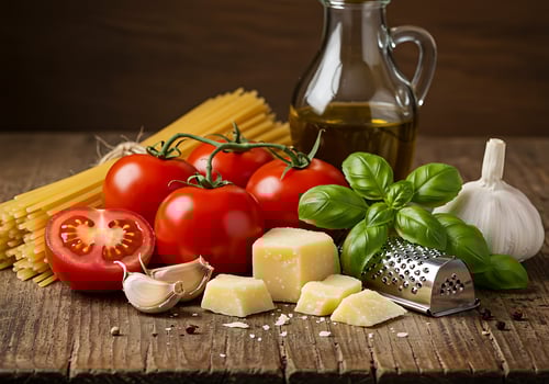 A wooden table with tomatoes, cheese, garlic, and basil photo
