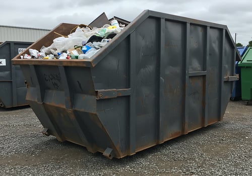 A large dumpster with a lot of trash in it photo