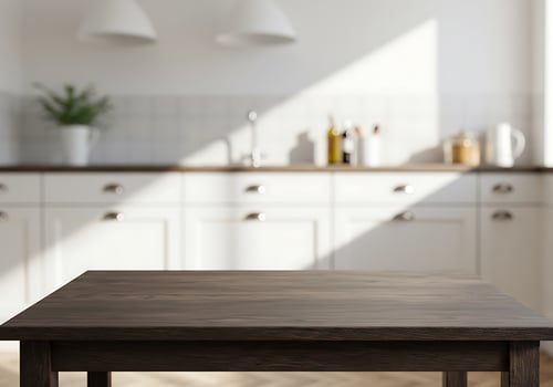 A table in a kitchen with white cabinets photo