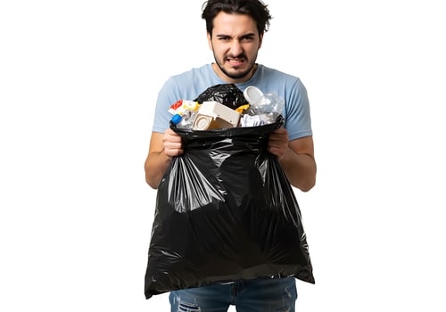 A man holding a garbage bag with trash in it photo