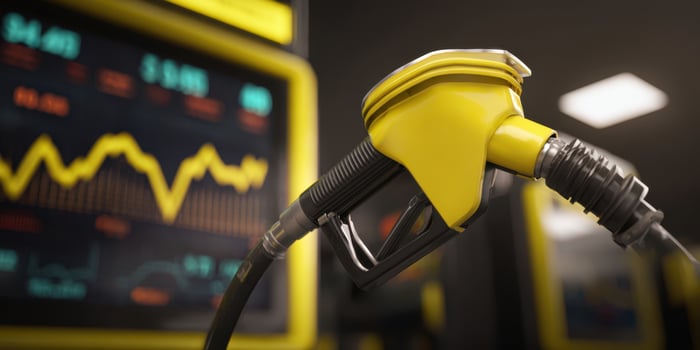 The yellow fuel pump against a backdrop of financial market trends and data analysis. photo