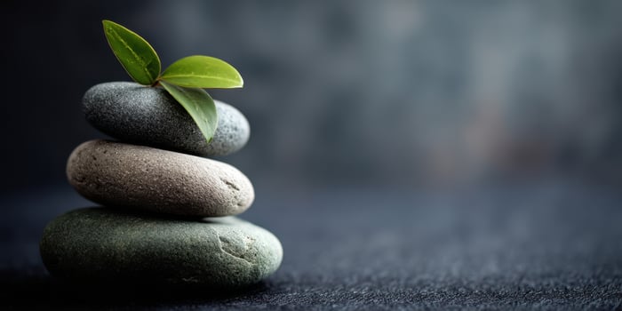 The harmonious stack of stones with a green leaf symbolizing tranquility. photo