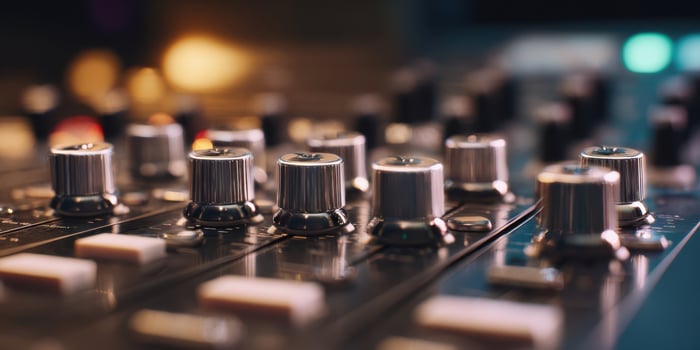The close-up view of professional audio mixer knobs and controls in a studio. photo