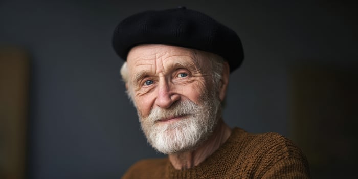 The smiling elderly man wearing a beret in a warm and inviting portrait. photo