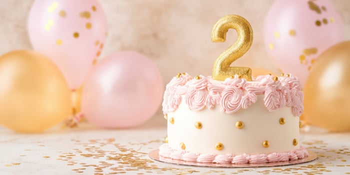 The beautifully decorated birthday cake showcasing a gleaming number two. photo