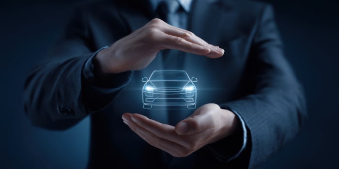The businessman showcases a holographic car within his hands demonstrating innovation. photo