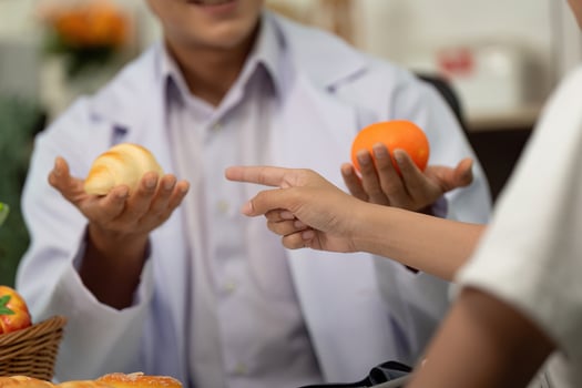Healthy Choices. Doctor presenting food options to a patient during a consultation. photo