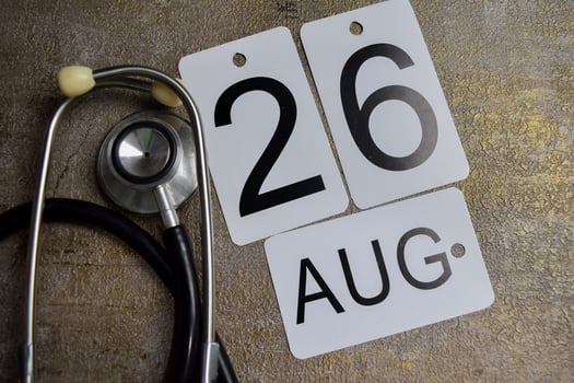 Date of August 26th and stethoscope on wooden table. Save the date. Day of the year concept photo