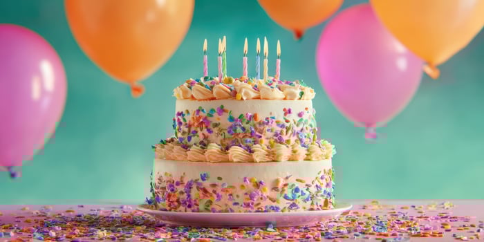 The colorful cake adorned with sprinkles and candles, ready for celebration. photo