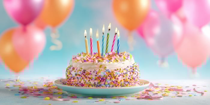 The colorful birthday cake with candles and balloons for a fun celebration. photo