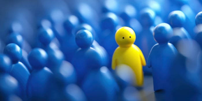The Yellow Figure Standing Out in a Sea of Blue Characters photo