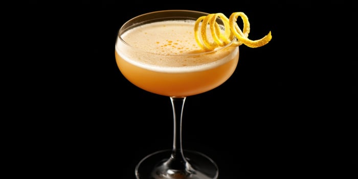 The elegant cocktail garnished with a twist of lemon peel. photo