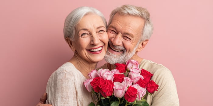 The joyful couple embracing with a beautiful bouquet of roses photo