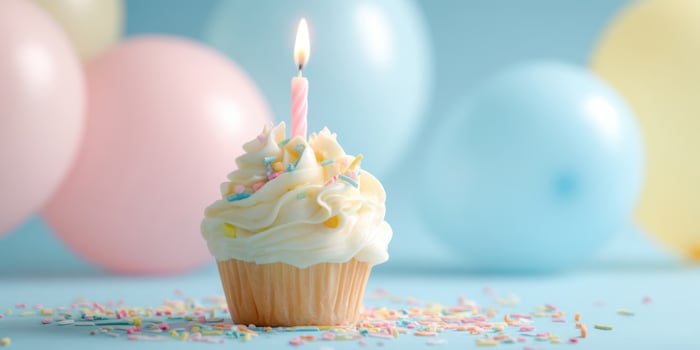 The delightful cupcake with a candle on a festive, pastel backdrop. photo