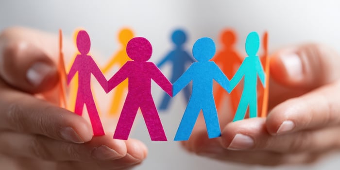 The colorful paper figures representing unity and support among diverse individuals. photo