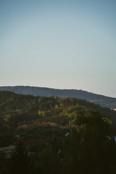 A plane flying over a hill photo