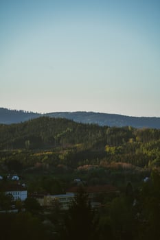 A plane flying over a city with a mountain in the background photo