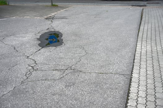 Puddle Reflection on Cracked Asphalt photo