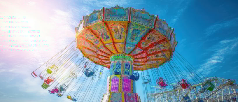The vibrant swing ride spinning joyfully against a bright blue sky photo