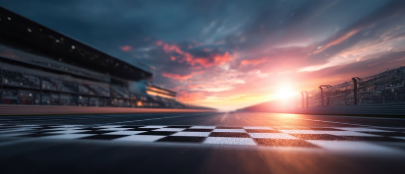 The checkered finish line under a dramatic sunset at the racetrack. photo