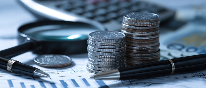 The arrangement of coins, pens, and calculator on financial documents photo
