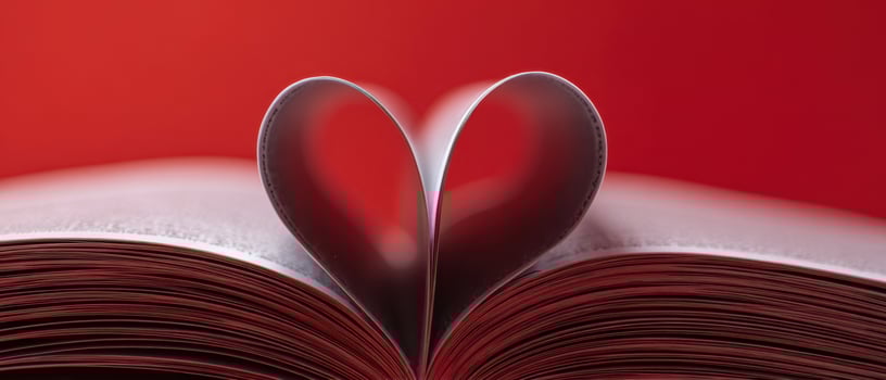 The Heart-Shaped Pages of an Open Book Against a Red Background photo