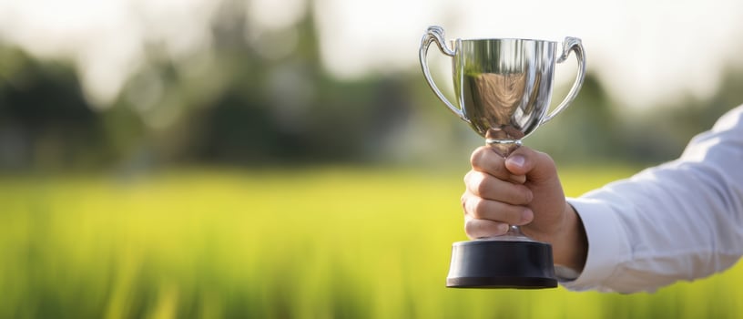 The trophy held high against the vibrant green field backdrop. photo