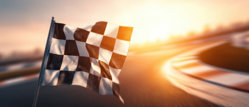 The checkered flag waving victoriously at a racing event on sunset. photo