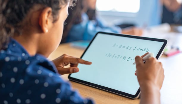 Student Engaged in Digital Learning, Interacting with Tablet Screen and Handwritten Equations photo