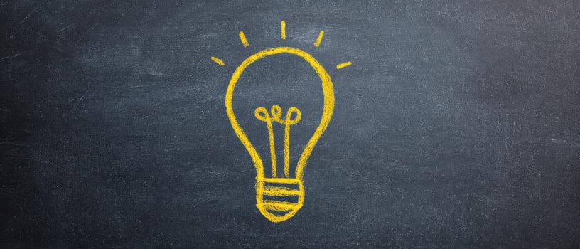The lightbulb symbolizing creativity and inspiration on a chalkboard. photo