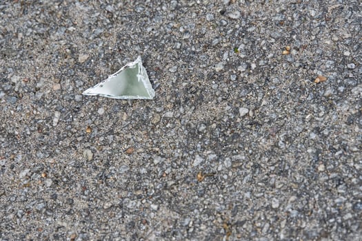Broken Glass Shard on Asphalt photo