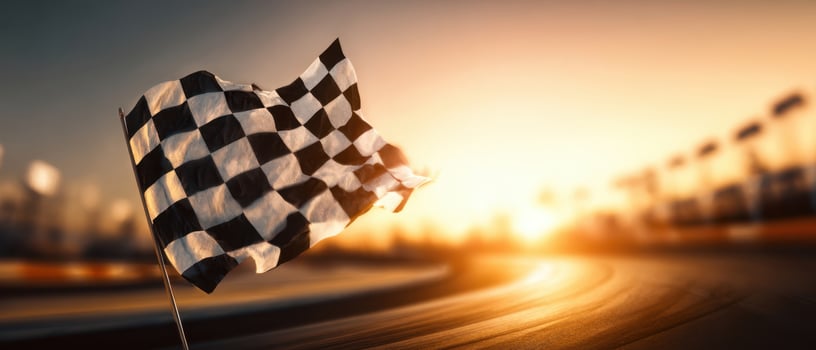 The checkered flag waving proudly at sunset on a race track. photo