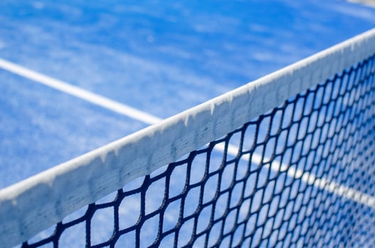 Detail of the white top band of a padel court net. photo
