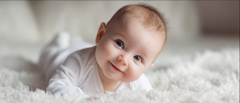 The adorable baby smiling joyfully on a soft, fluffy background. photo
