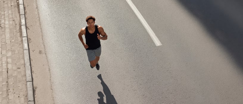 The athlete running on the street, showcasing determination and fitness in motion. photo