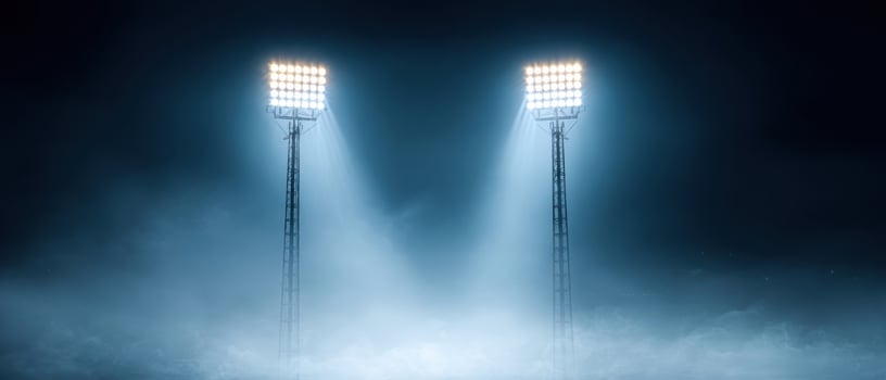The Powerful Stadium Lights Cutting Through the Foggy Night Sky photo