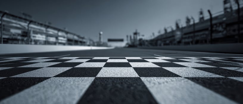 The checkered finish line at a racing track captured from a low perspective. photo