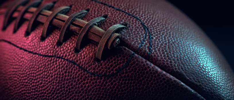 The detailed texture of a classic football on a dark background. photo