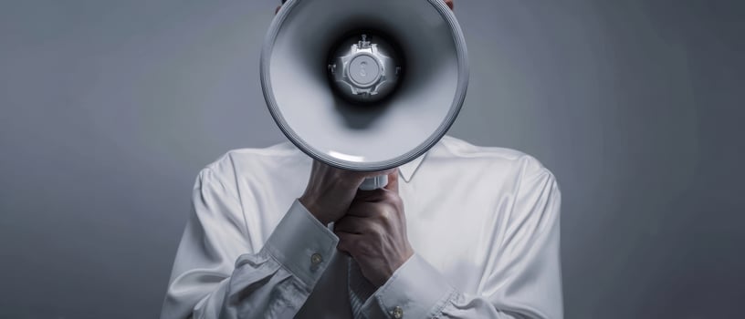 The man using a megaphone to amplify his message in a modern environment. photo