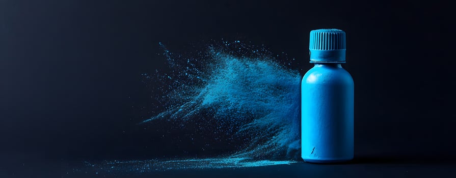Blue Powder Explosion Beside a Bottle Dramatic Product Photography photo
