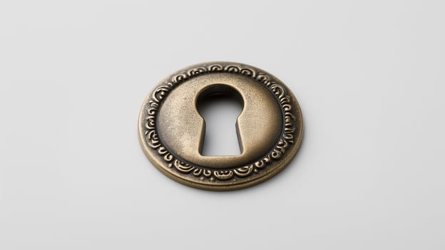 Ornate antique bronze keyhole escutcheon on a gray background photo