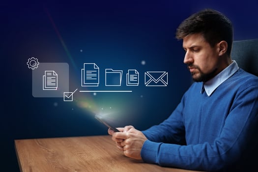 Efficient digital organization by a man using a smartphone in a modern office environment at night photo