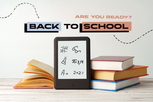 Prepare for the academic year with books, a tablet, and motivational text displayed on a clean workspace photo