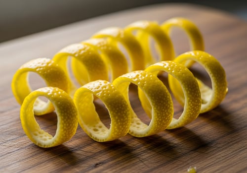 Lemon Zest Curls on Wooden Cutting Board in Natural Light photo