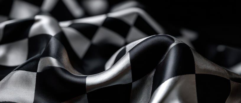 The elegant interplay of black and silver satin fabric in luxurious folds. photo