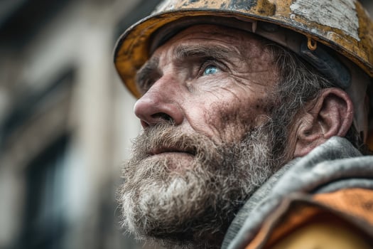 A close up of a man with a beard and hard hat photo